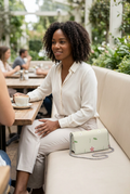 Kenway bag naturally resting beside model on café bench
